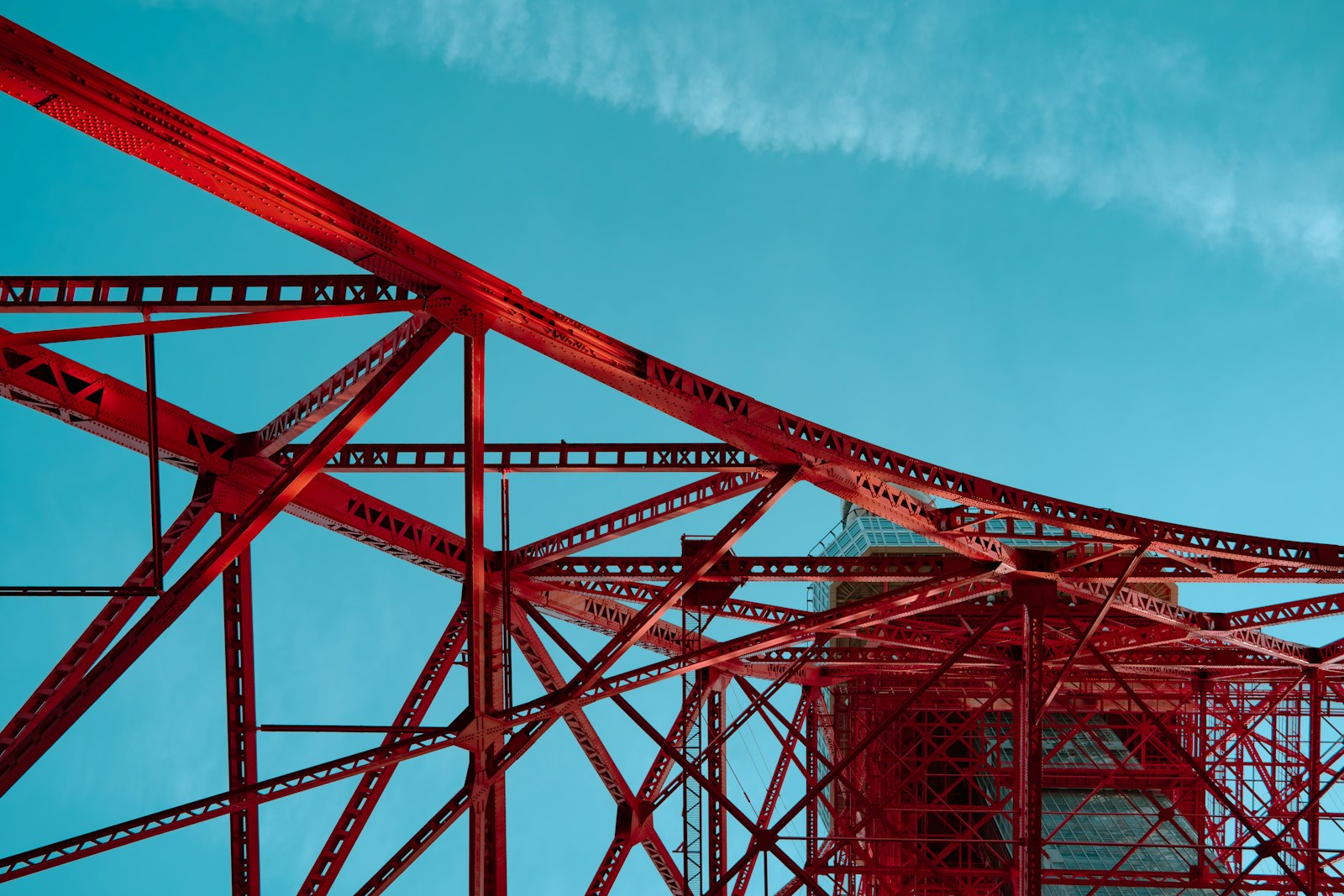 Red steel truss structure showing how lightweight design uses material along load paths